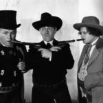 The Three Stooges, two with guns in their mouths.