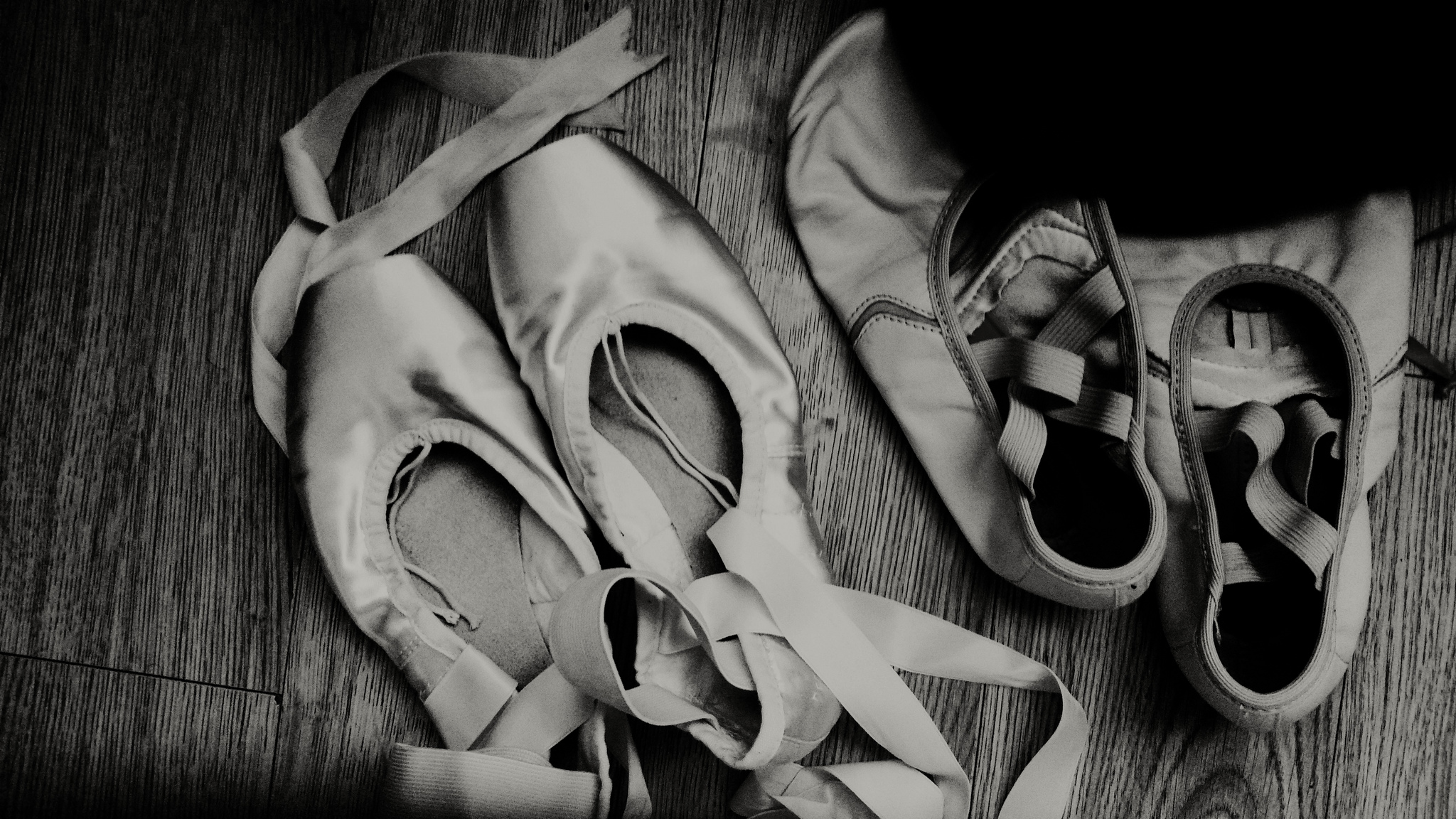 Black and white photograph demi-pointe shoes on left, MDM flats on the right.