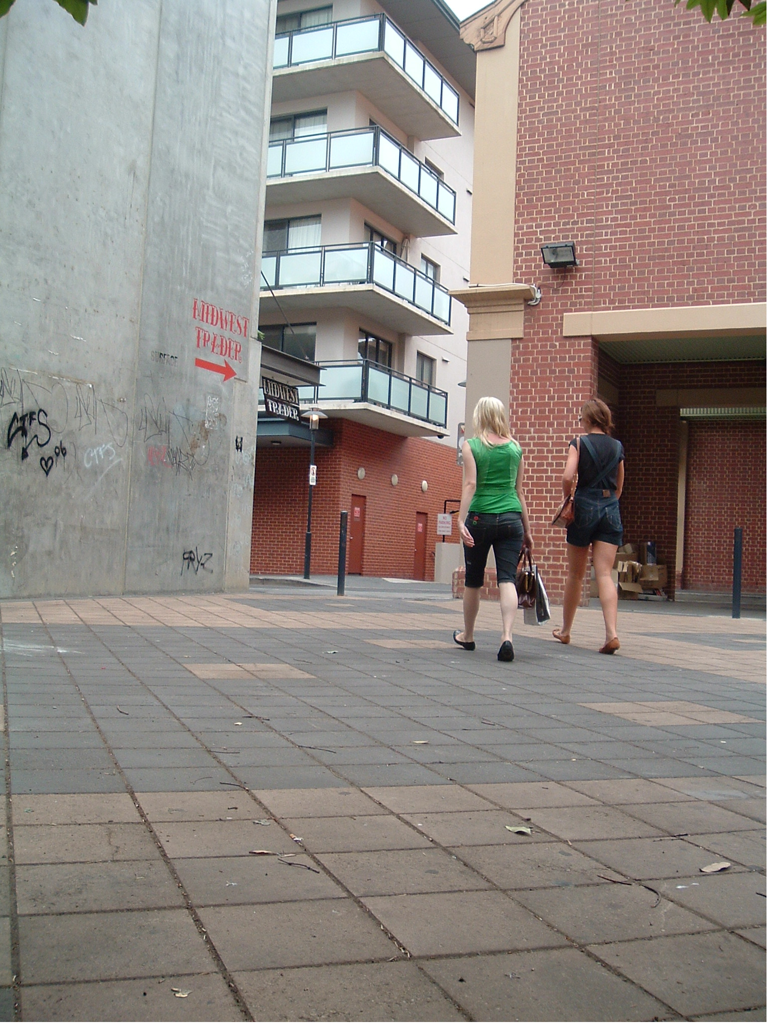 Photograph of two girls walking with shopping